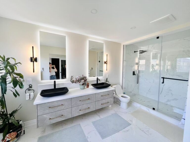 Mississauga bathroom renovation with circular LED mirror, quartz vanity, and walk-in shower