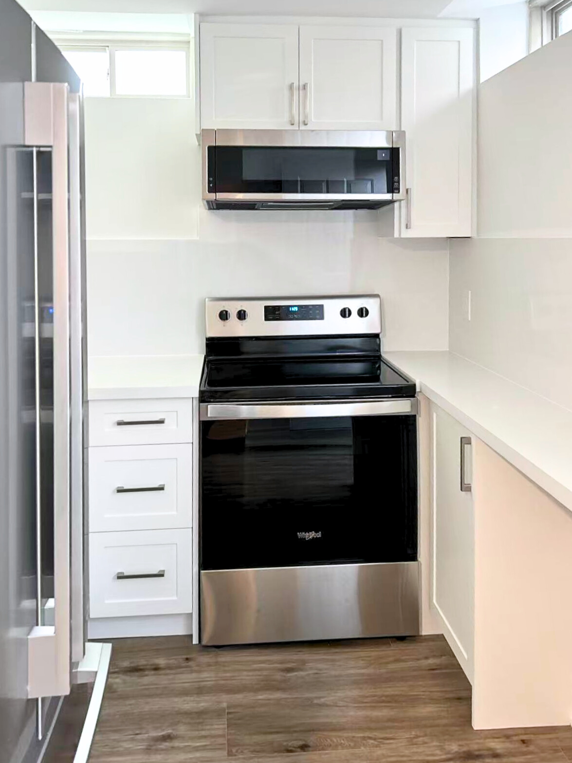 Oshawa kitchen renovation with white cabinets and dark floor tiles