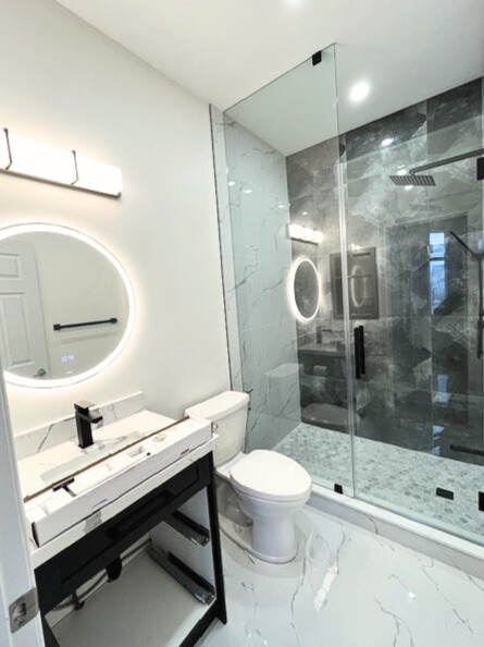 White textured tiles and frameless shower