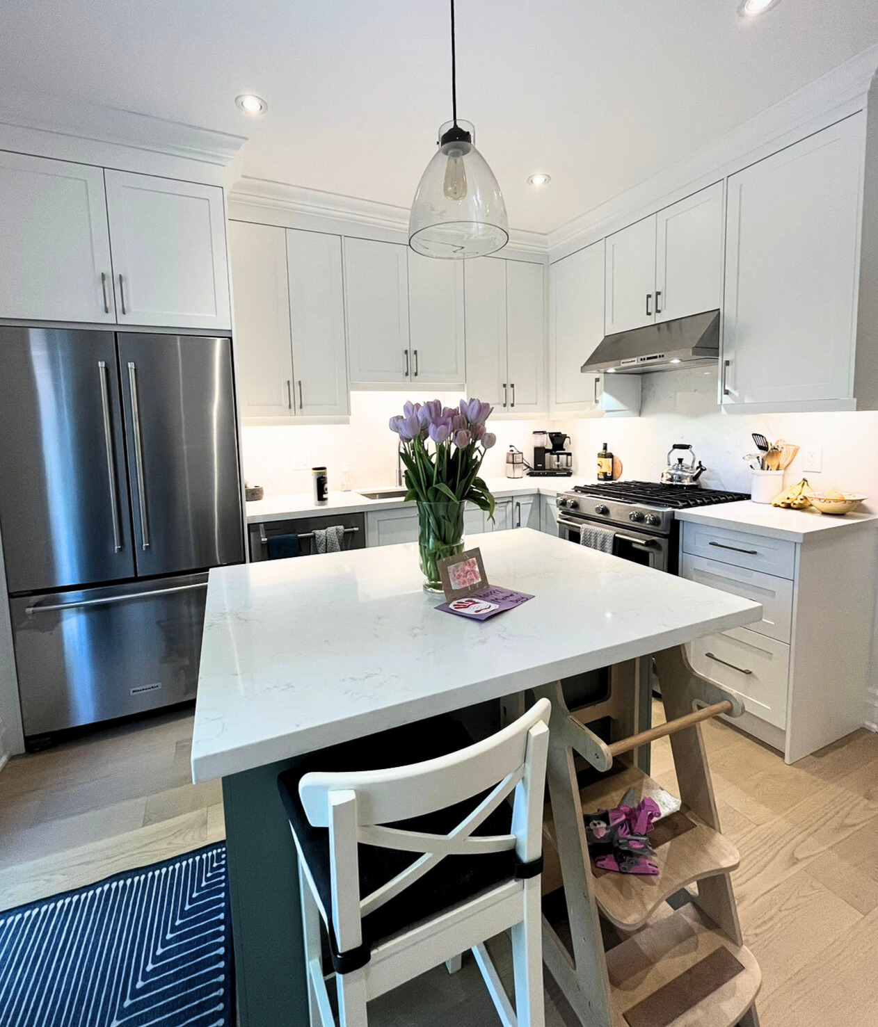 Toronto kitchen renovation with white cabinets and light hardwood flooring