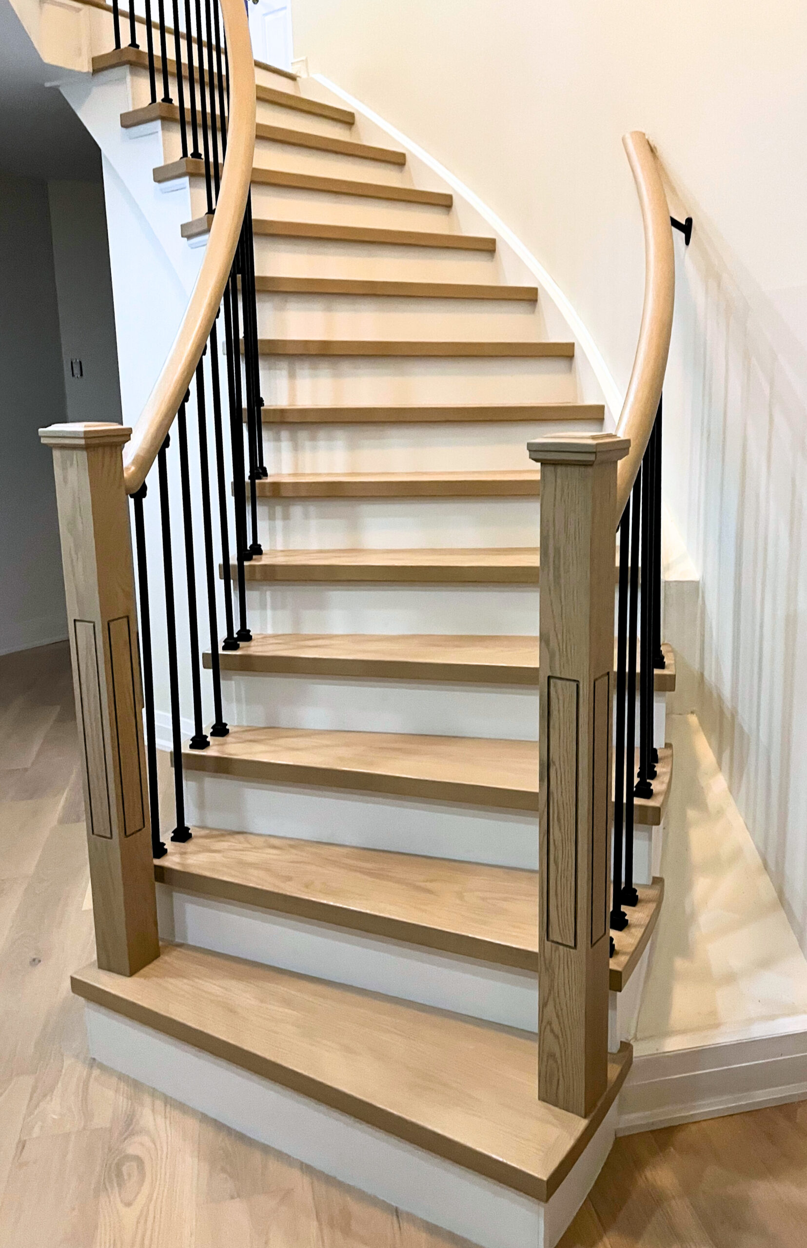 Mississauga light wood staircase renovation with matching curved handrail