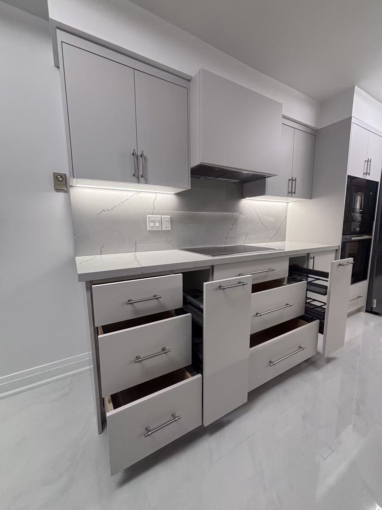 Modern condo renovation with white interior and dark-tile bathroom