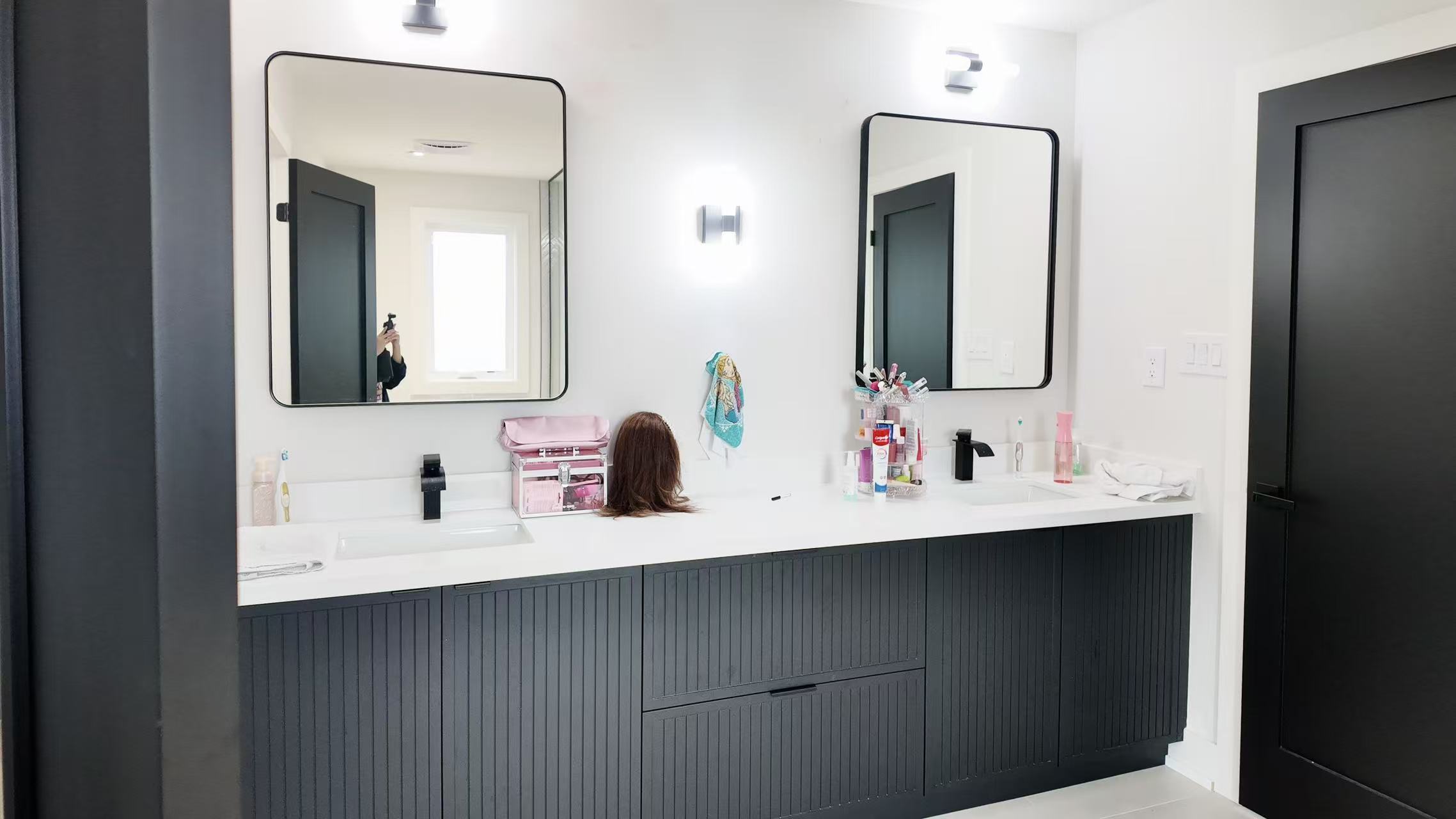 Double vanity with gold-framed shower in Woodbridge renovation