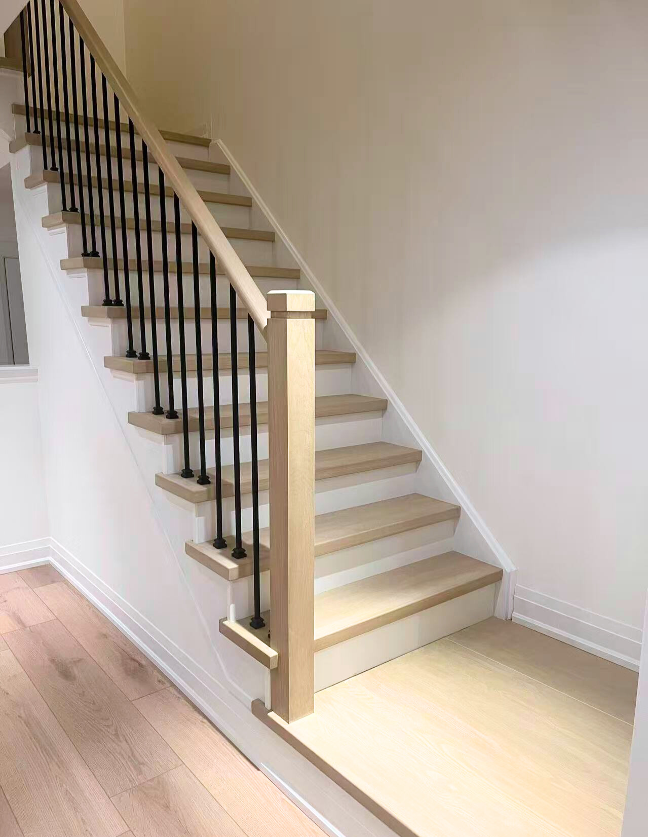 69 Woodbridge light wood staircase renovation with black balusters