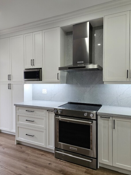 White cabinetry and dark wood floor kitchen renovation
