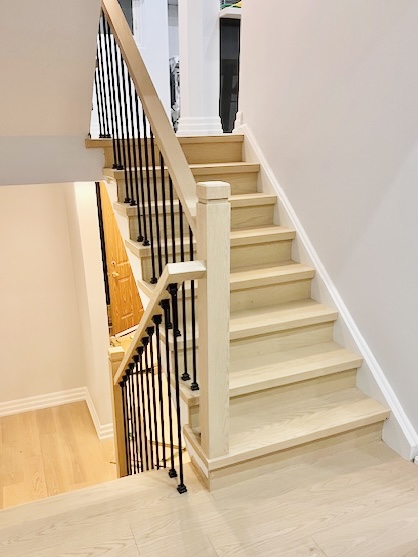 North York 81 staircase renovation with straight light oak stairs and uniform color design