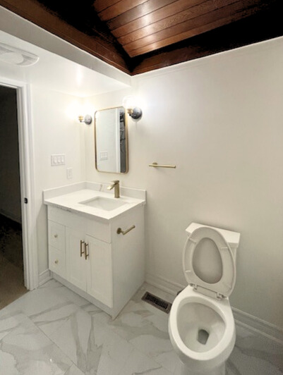 After — shower with gold fixtures